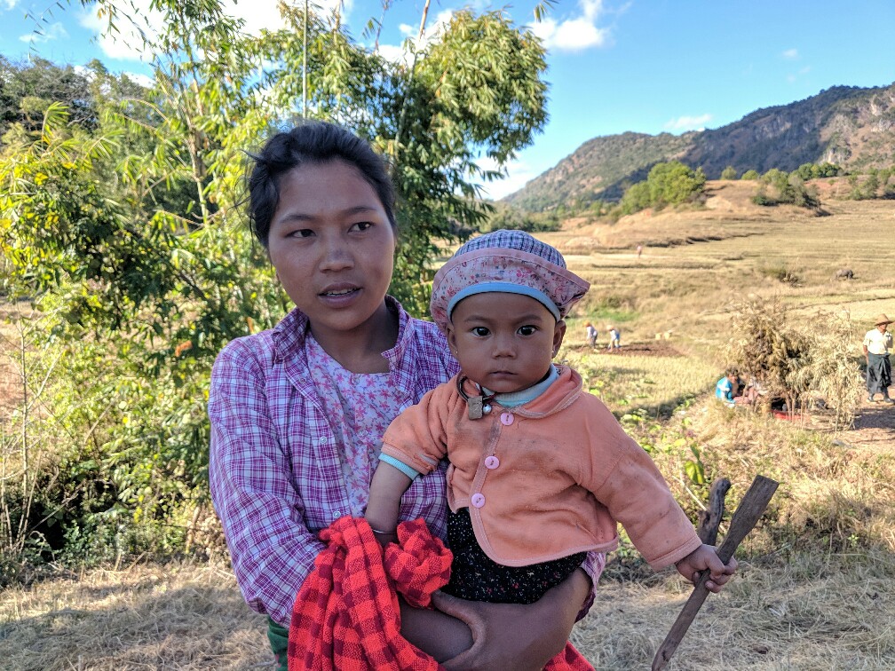 Une mère et son bébé dans un champs sur le trek de Kalaw à Inle en Birmanie