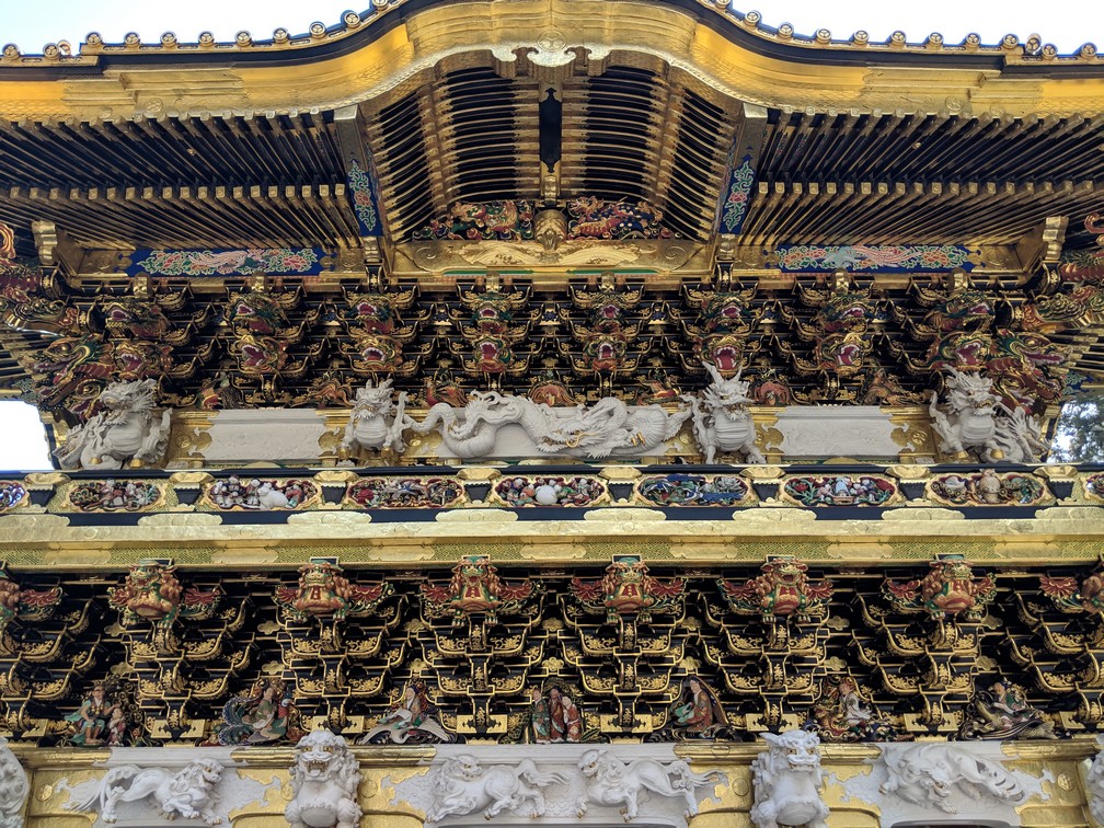 motifs dorés décoratifs sur une grosse porte d'entrée vers le sanctuaire Toshogu à Nikko
